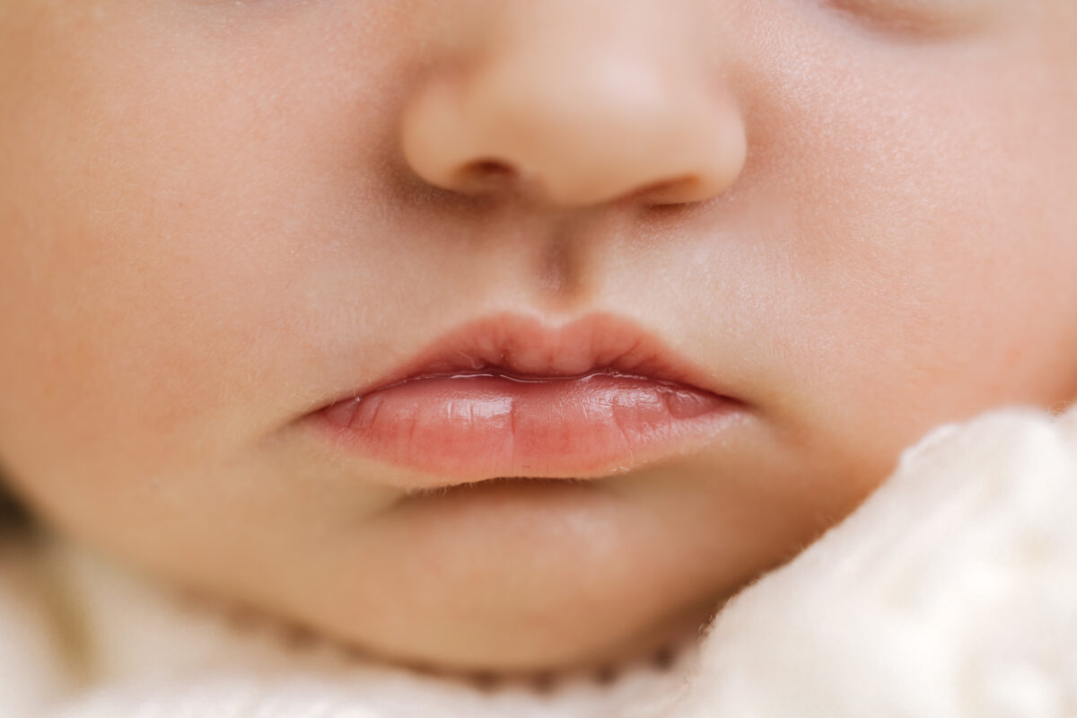 Close-up of a newborn baby's lips and nose during a detailed photography session by Little Miracles Photography Studio.