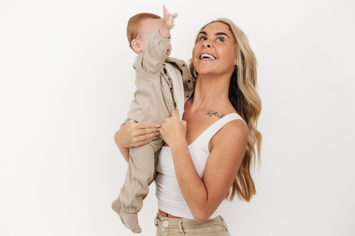 Natural mother and son portrait captured before a first birthday cake smash.