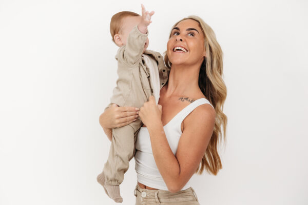 Natural mother and son portrait captured before a first birthday cake smash.