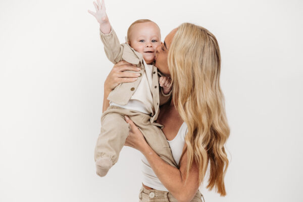 Natural mother and son portrait captured before a first birthday cake smash.