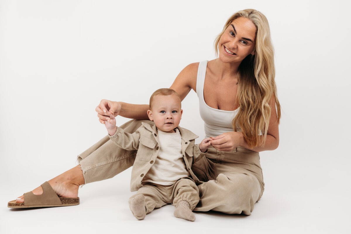 Natural mother and son portrait captured before a first birthday cake smash.