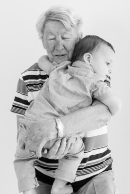 Baby Boy hugging great grandmother before his First Birthday Cake Smash Photography