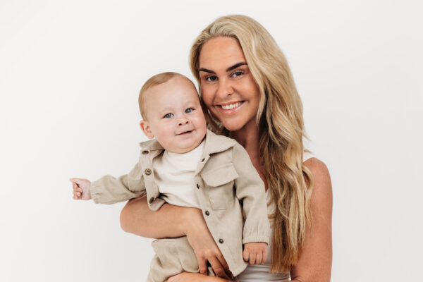 Baby Boy posing with mum before First Birthday Cake Smash Photography