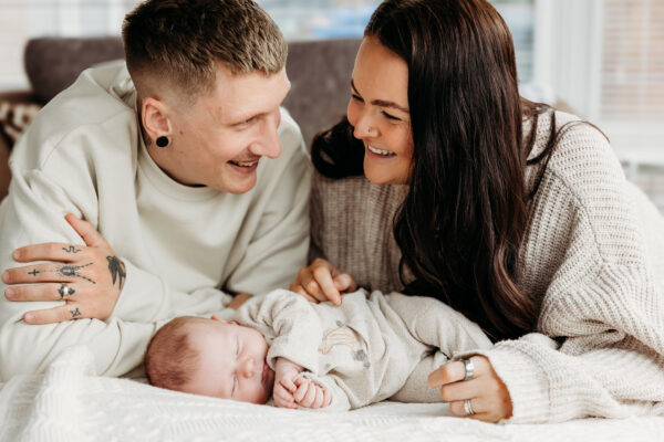 Family laughing together during a professional family photography session.