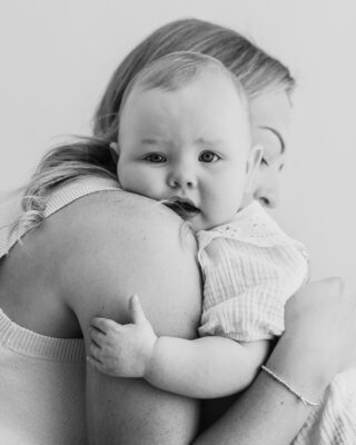 Mum cuddling her child during a relaxed studio portrait session.