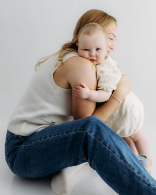 Mum cuddling her child during a relaxed studio portrait session.